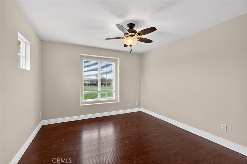 1277 Baxter Drive Merced, CA 95348 - Photo 44 of 63 a view of empty room with wooden floor and fan