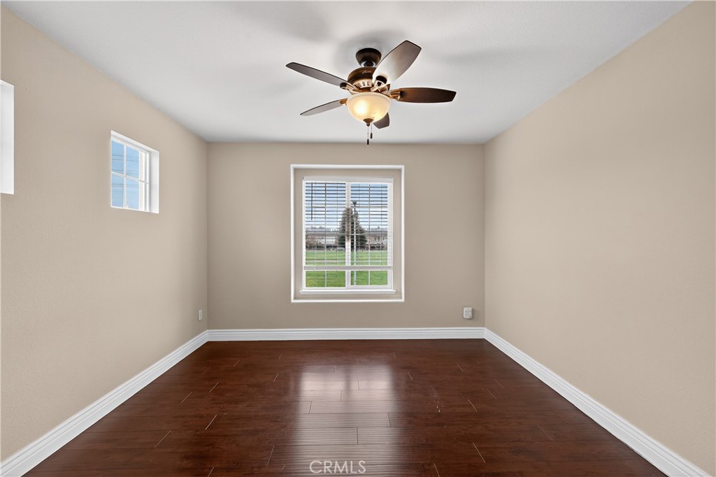 1277 Baxter Drive Merced, CA 95348 - Photo 45 of 63 a view of a livingroom with window a ceiling fan and wooden floor