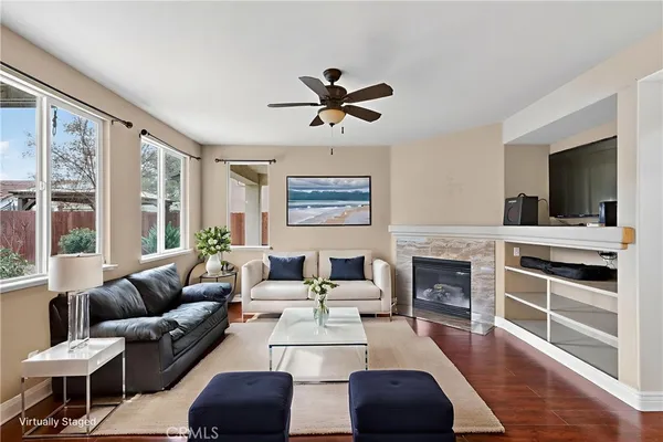 a living room with furniture fireplace and window