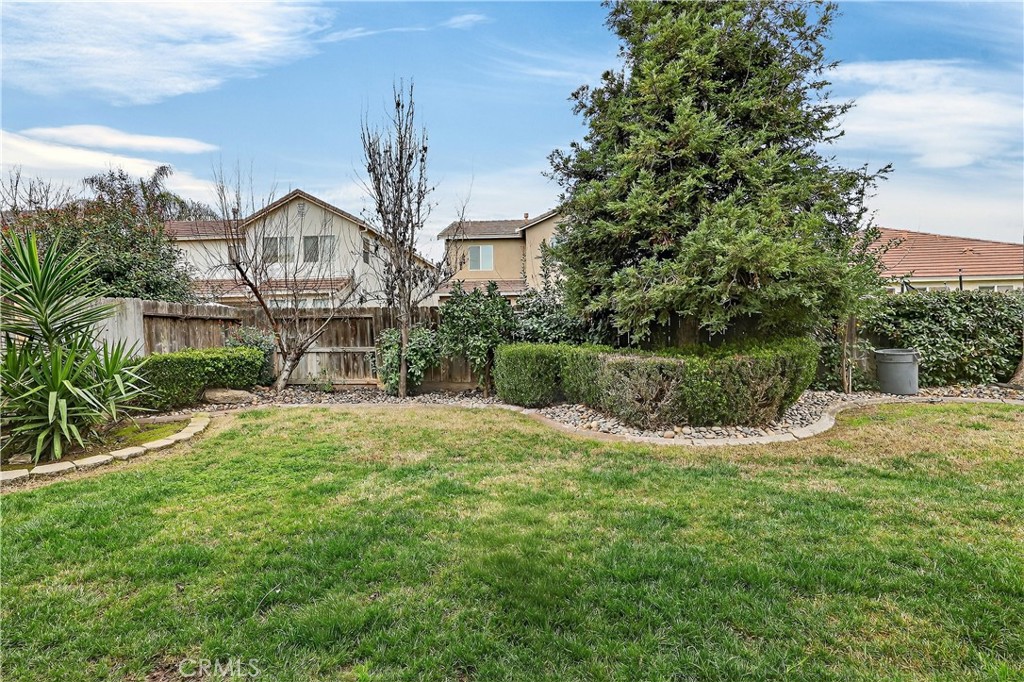 1277 Baxter Drive Merced, CA 95348 - Photo 56 of 63 a front view of a house with garden