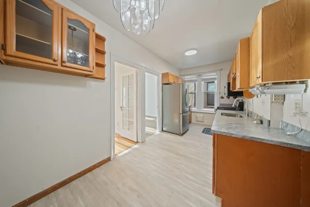 a large kitchen with a lot of counter space and wooden floor