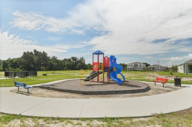a view of a park with swings and slides