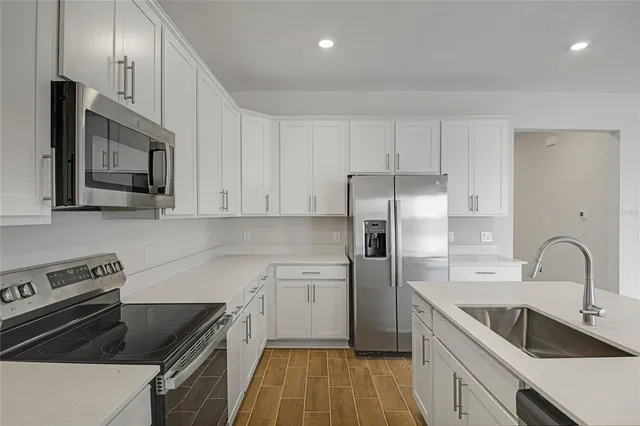 a kitchen with a sink stove and refrigerator