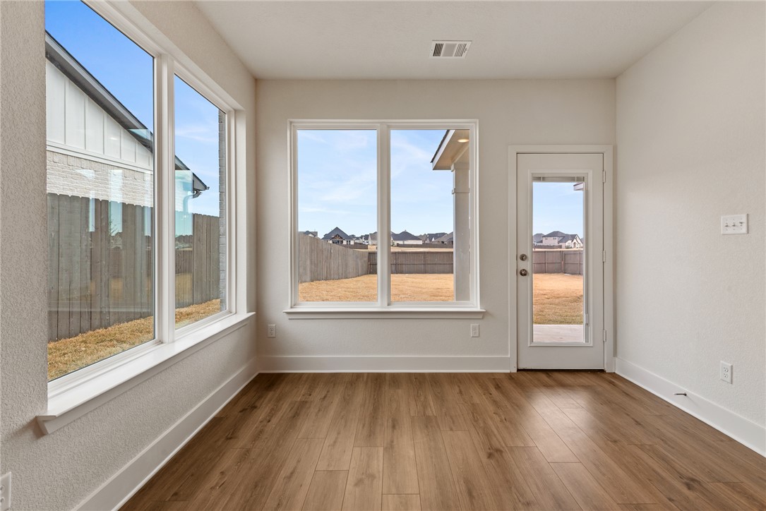5626 Hayduke Ln. Bryan, TX 77802 - Photo 13 of 49 a view of an empty room with a window and wooden floor