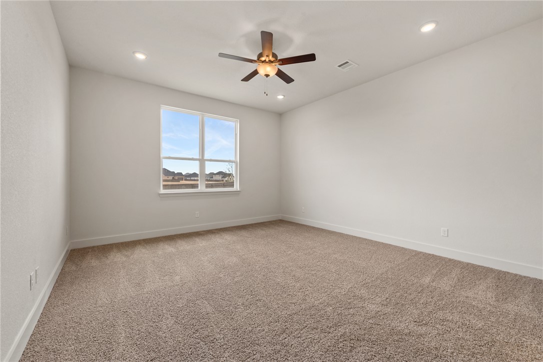 5626 Hayduke Ln. Bryan, TX 77802 - Photo 20 of 49 an empty room with windows and ceiling fan