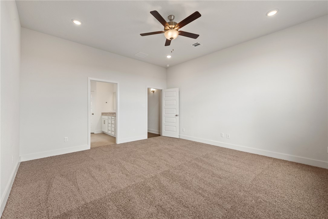 5626 Hayduke Ln. Bryan, TX 77802 - Photo 22 of 49 an empty room with a ceiling fan and a ceiling fan