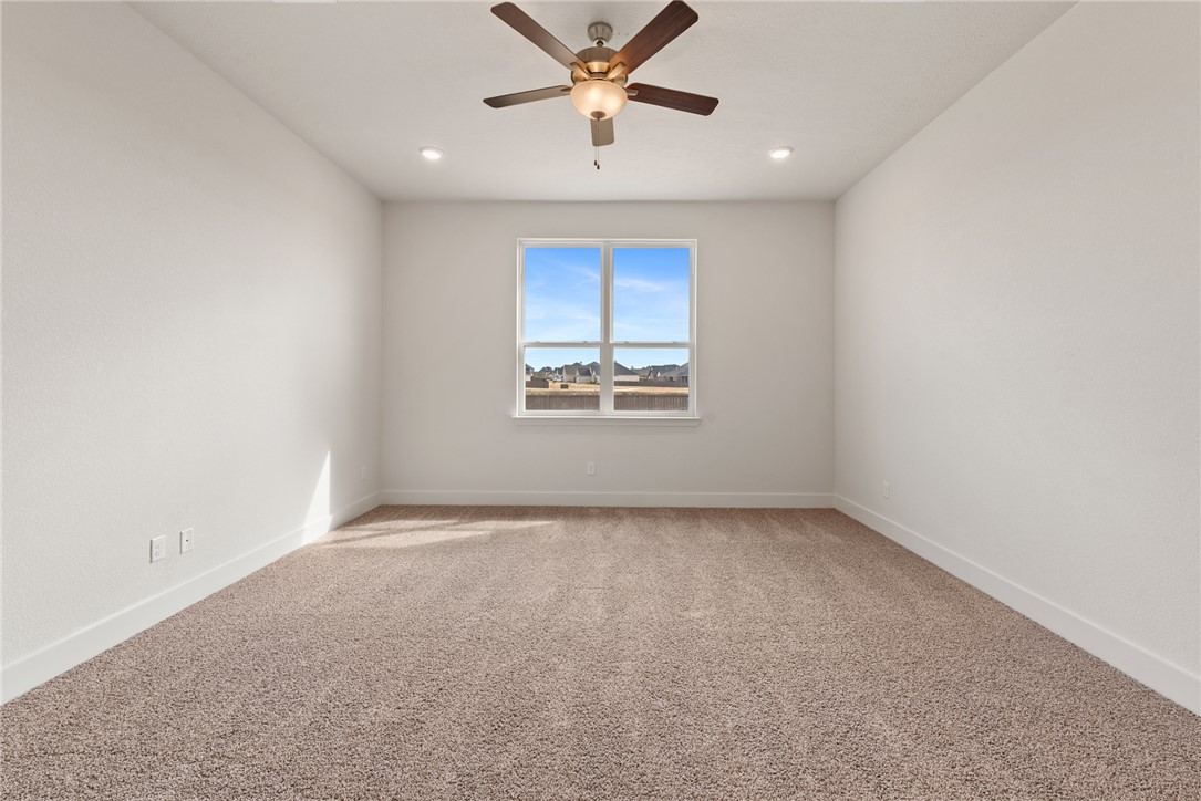 5626 Hayduke Ln. Bryan, TX 77802 - Photo 23 of 49 an empty room with a window and a ceiling fan