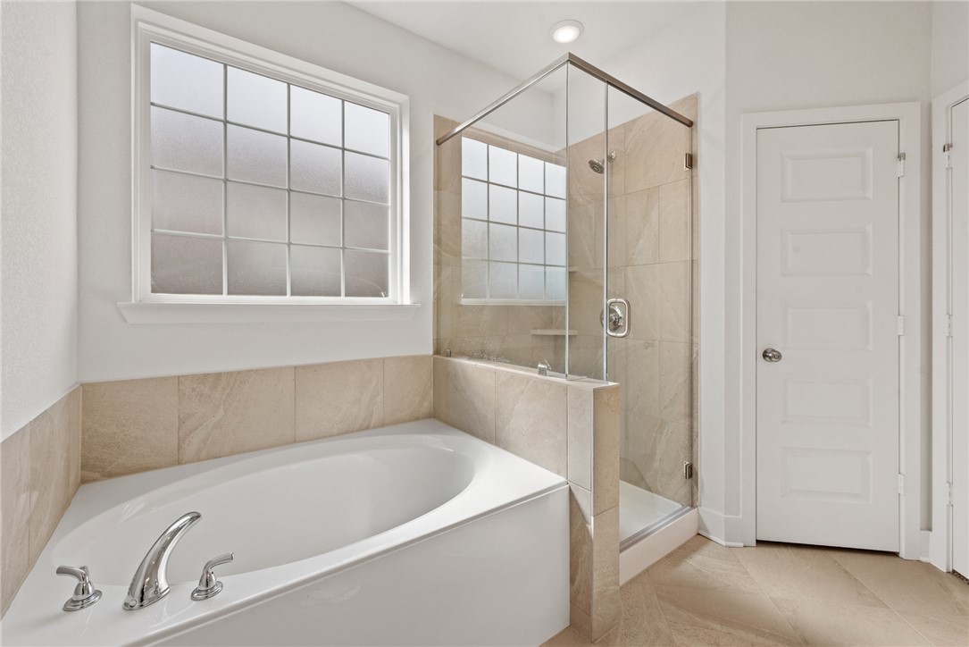 5626 Hayduke Ln. Bryan, TX 77802 - Photo 27 of 49 a white bath tub sitting next to a shower