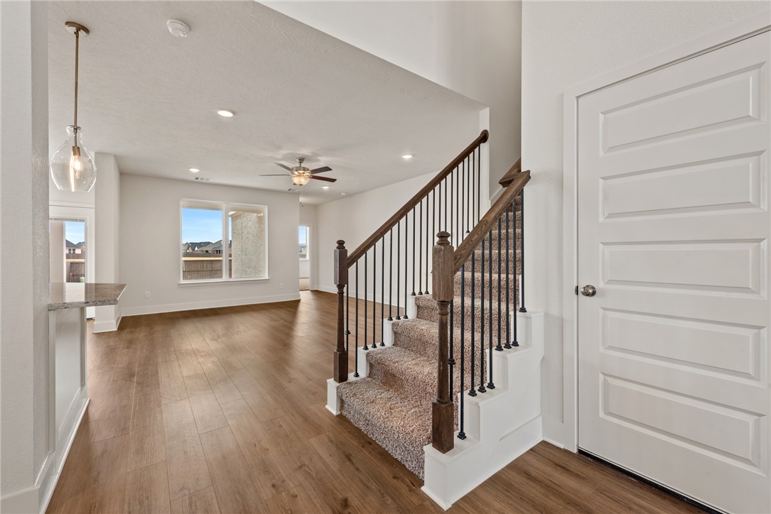 5626 Hayduke Ln. Bryan, TX 77802 - Photo 30 of 49 a view of a hallway with wooden floor and windows