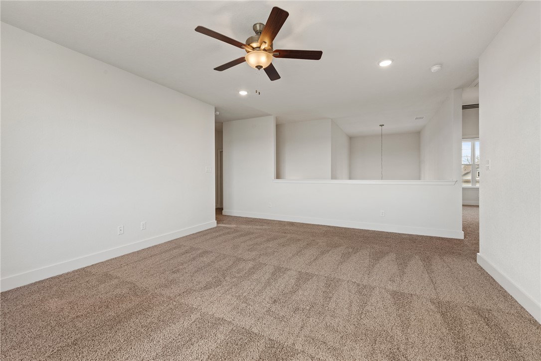 5626 Hayduke Ln. Bryan, TX 77802 - Photo 34 of 49 an empty room with chandelier fan and windows