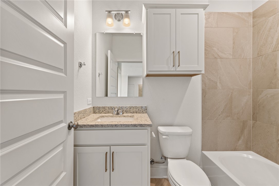 5626 Hayduke Ln. Bryan, TX 77802 - Photo 36 of 49 a bathroom with a sink toilet vanity and tub