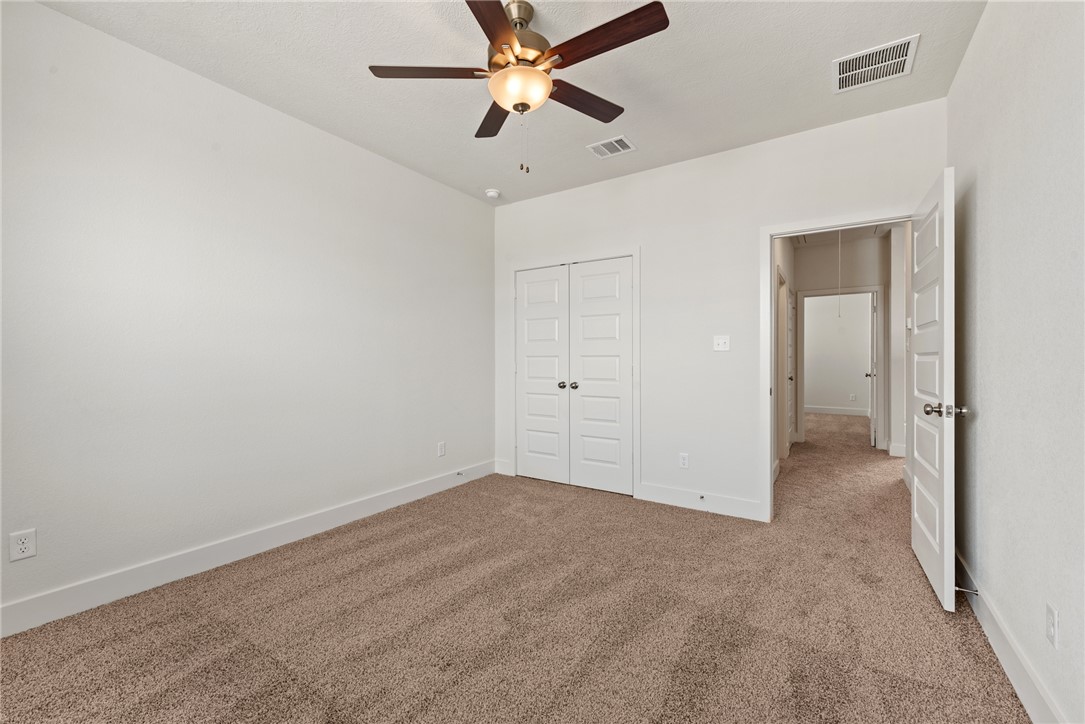 5626 Hayduke Ln. Bryan, TX 77802 - Photo 39 of 49 an empty room with chandelier fan