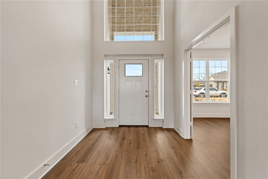 5626 Hayduke Ln. Bryan, TX 77802 - Photo 4 of 49 an empty room with wooden floor and windows