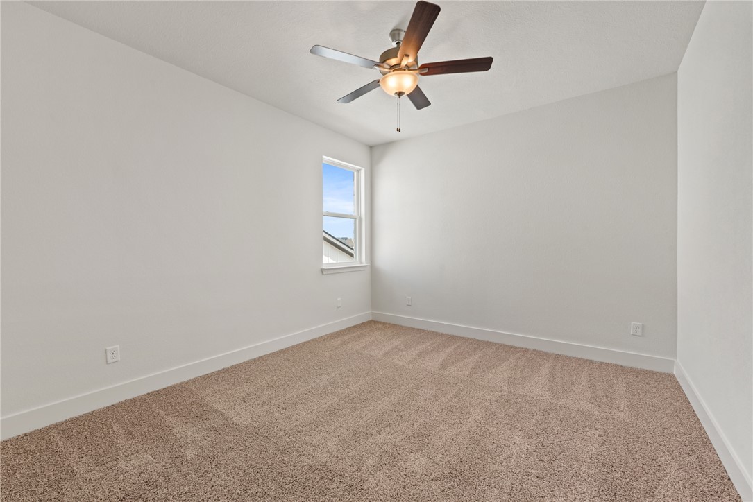 5626 Hayduke Ln. Bryan, TX 77802 - Photo 41 of 49 an empty room with windows and fan