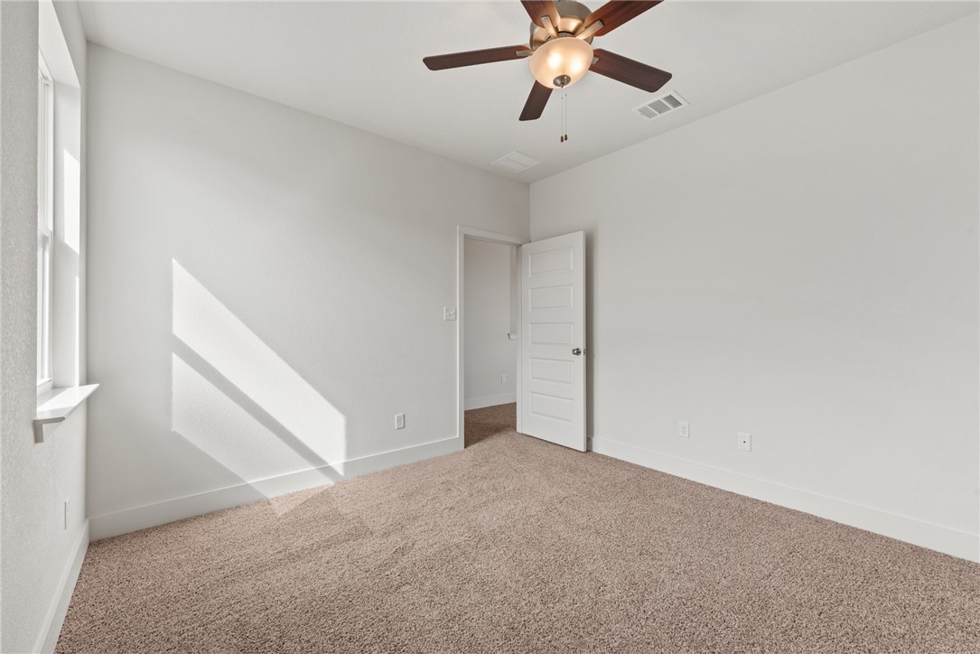 5626 Hayduke Ln. Bryan, TX 77802 - Photo 44 of 49 an empty room with windows and fan