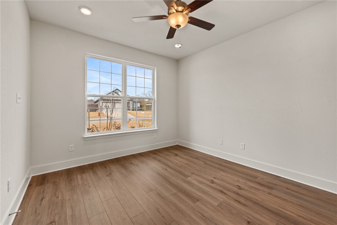 5626 Hayduke Ln. Bryan, TX 77802 - Photo 5 of 49 wooden floor in an empty room with a window