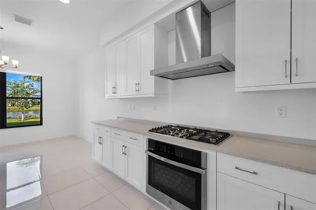 a kitchen with a refrigerator and a stove top oven
