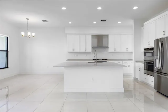 a kitchen with stainless steel appliances a refrigerator sink and microwave