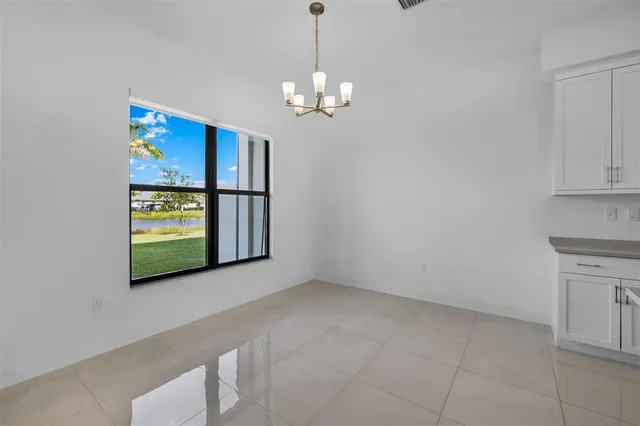 a view of kitchen with center island stainless steel appliances wooden floor and living room view