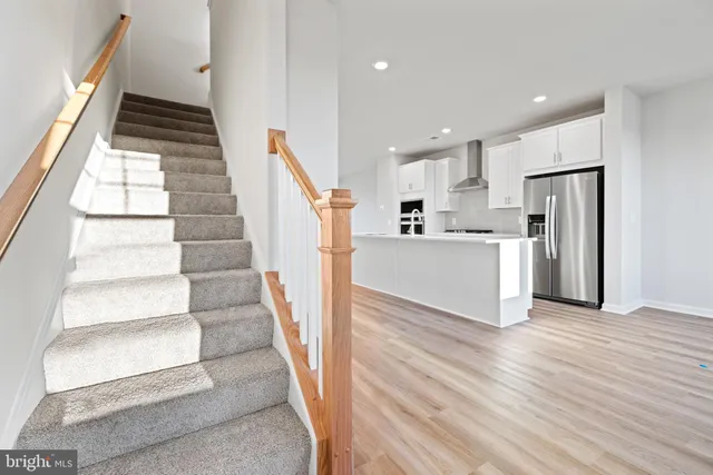 a view of a kitchen with wooden floor and electronic appliances
