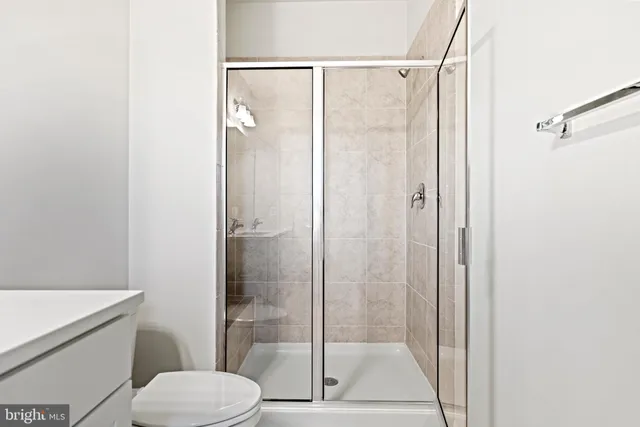 a bathroom with a shower a toilet and a sink