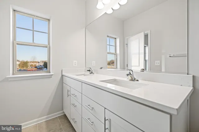 a bathroom with 2 sink and a mirror