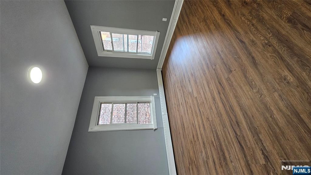 78 North Arlington Avenue, Unit 2 East Orange, NJ 07017 - Photo 3 of 9 an empty room with wooden floor and windows