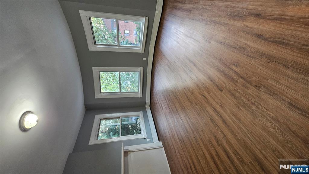 78 North Arlington Avenue, Unit 2 East Orange, NJ 07017 - Photo 4 of 9 an empty room with wooden floor and windows