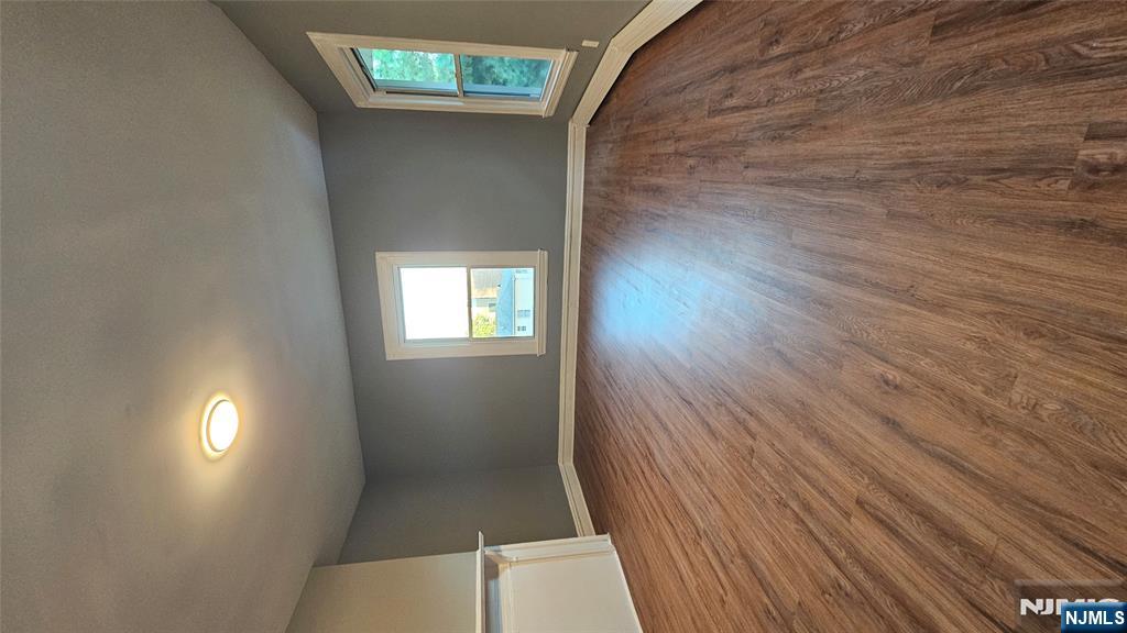 78 North Arlington Avenue, Unit 2 East Orange, NJ 07017 - Photo 5 of 9 an empty room with wooden floor and windows