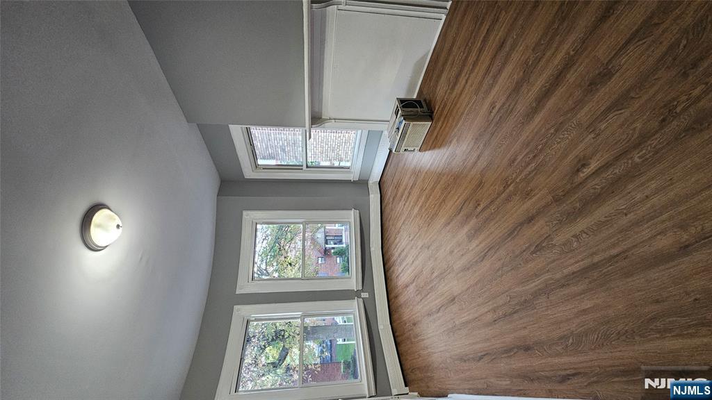 78 North Arlington Avenue, Unit 2 East Orange, NJ 07017 - Photo 6 of 9 an empty room with wooden floor and windows