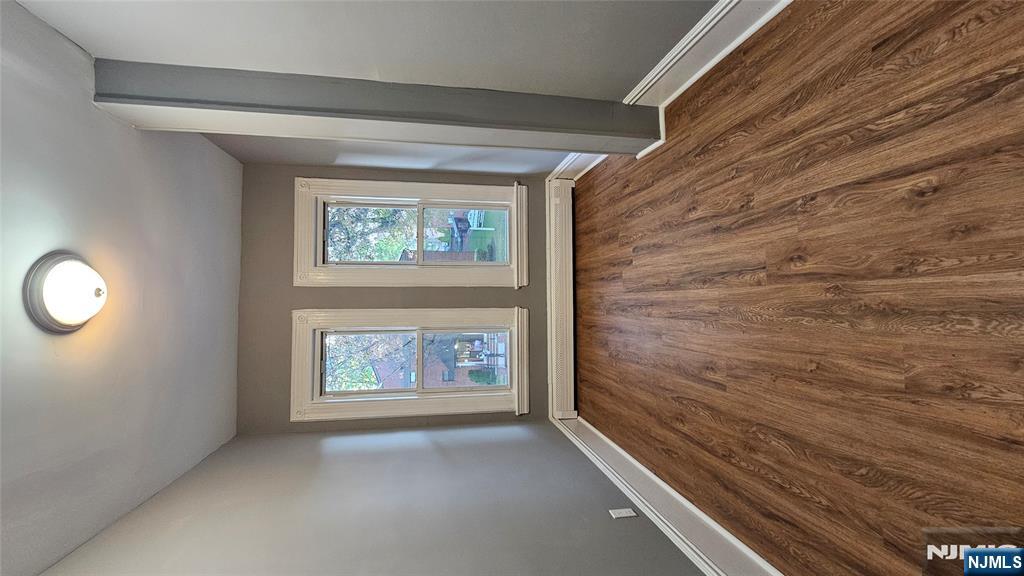 78 North Arlington Avenue, Unit 2 East Orange, NJ 07017 - Photo 7 of 9 an empty room with wooden floor and windows