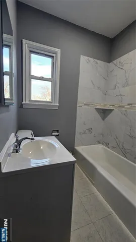 a bathroom with a bathtub and a sink
