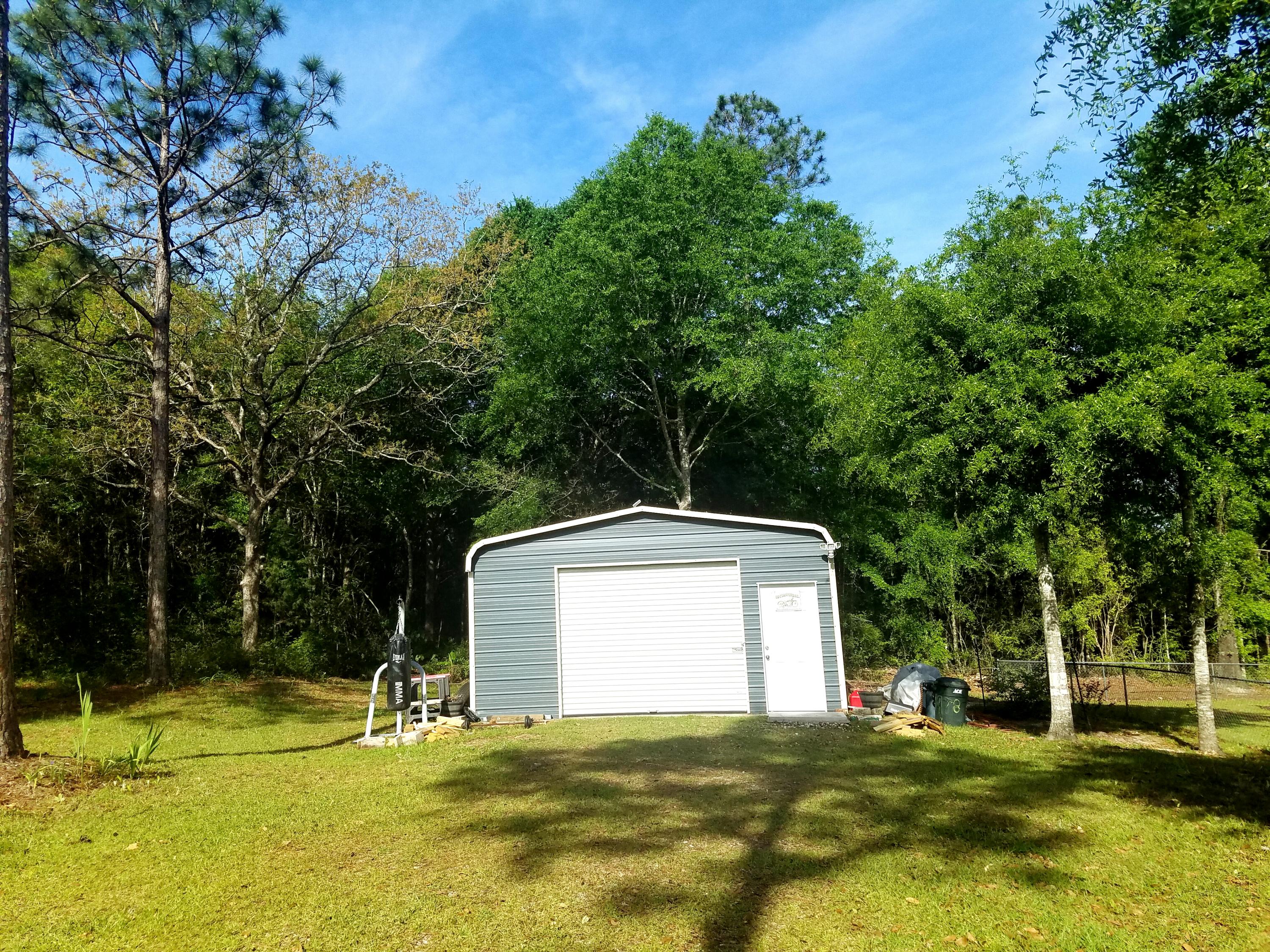 6298 Possum Ridge Road Crestview, FL 32539 - Photo 39 of 43 a view of a house with a yard