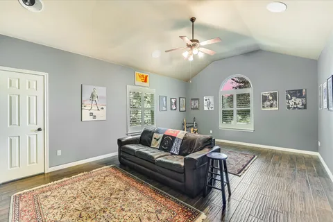 a spacious bedroom with a large bed and a chandelier