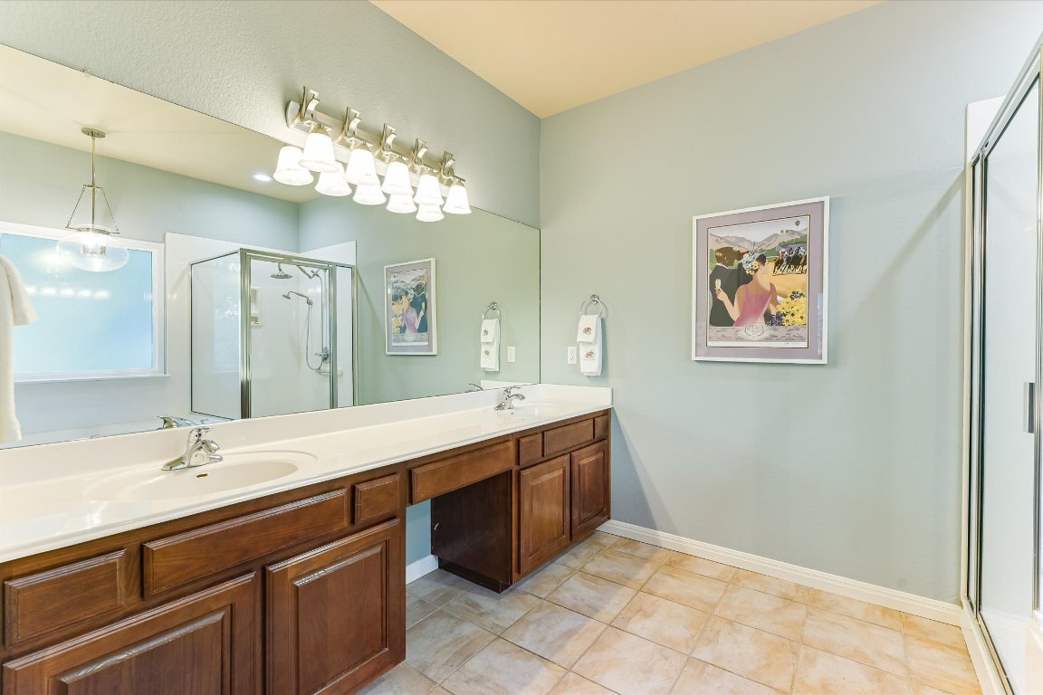 786 Ranchers Club Lane Driftwood, TX 78619 - Photo 18 of 33 a spacious bathroom with a double vanity sink mirror and double