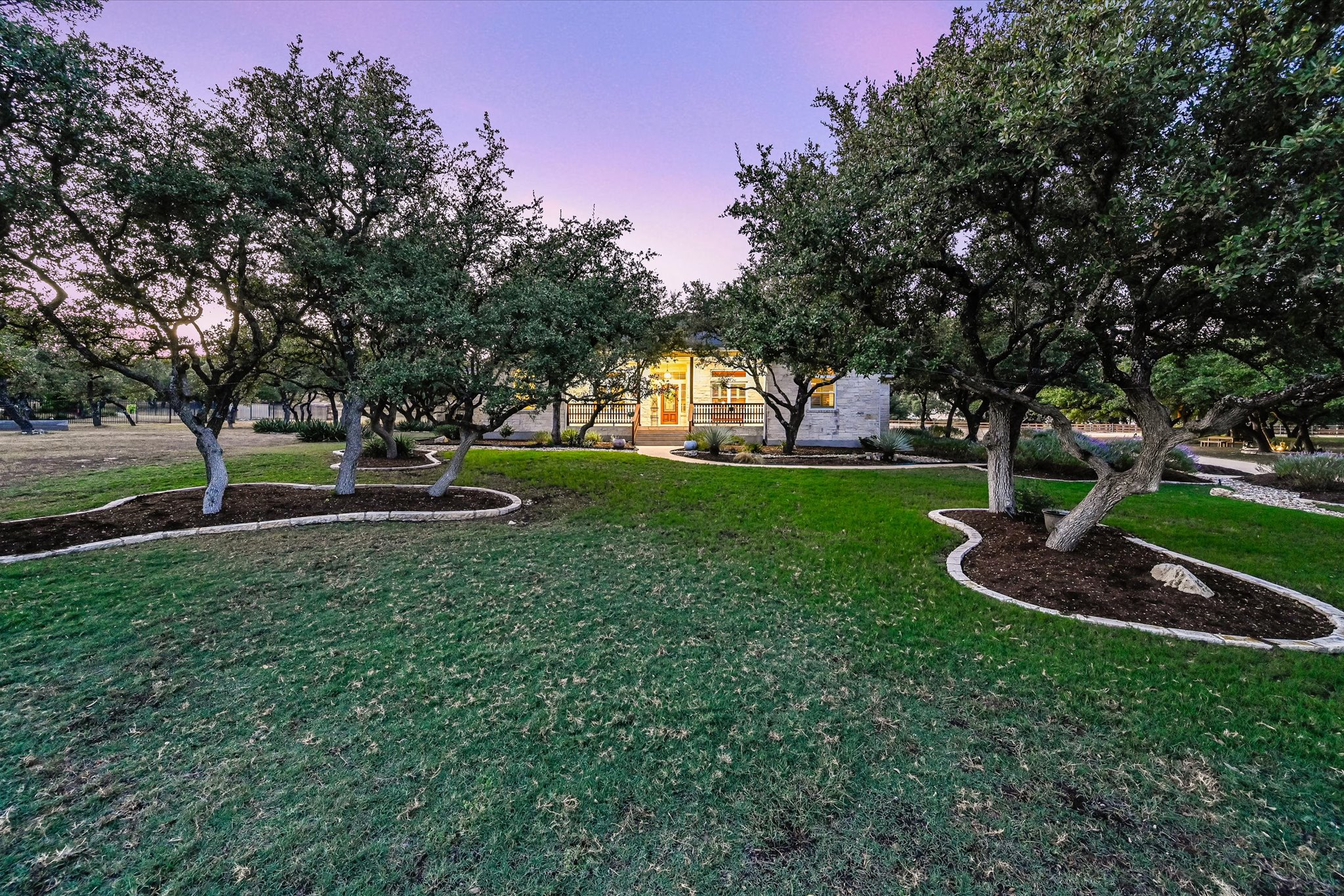 786 Ranchers Club Lane Driftwood, TX 78619 - Photo 2 of 33 Yard at dusk featuring a lawn