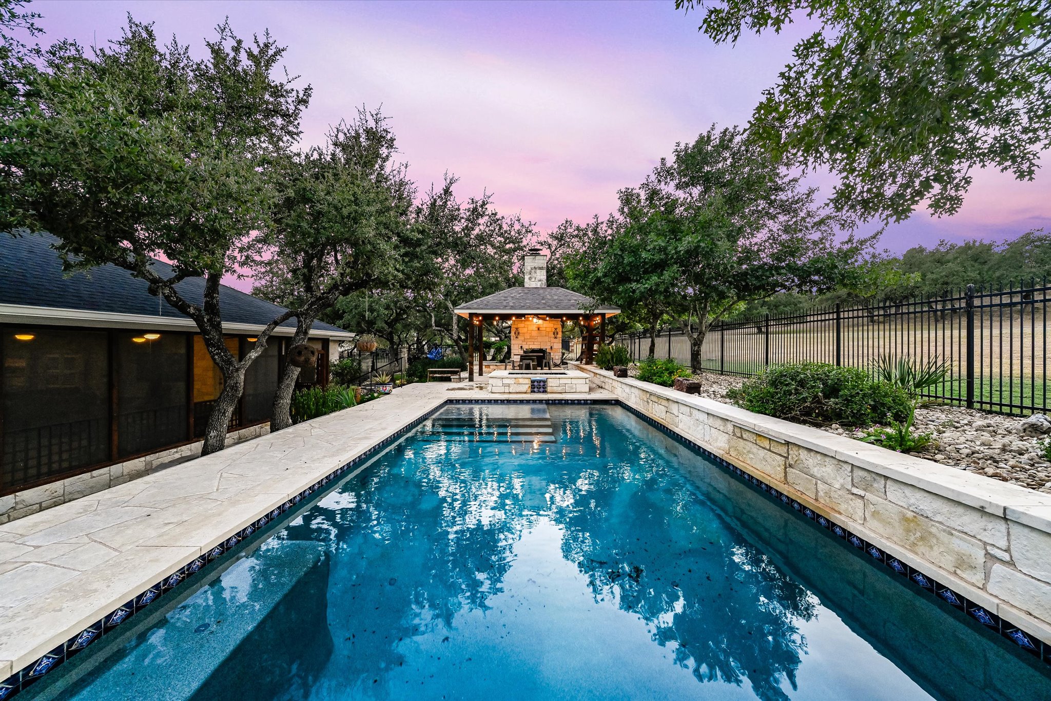 786 Ranchers Club Lane Driftwood, TX 78619 - Photo 29 of 33 Pool at dusk featuring a patio area