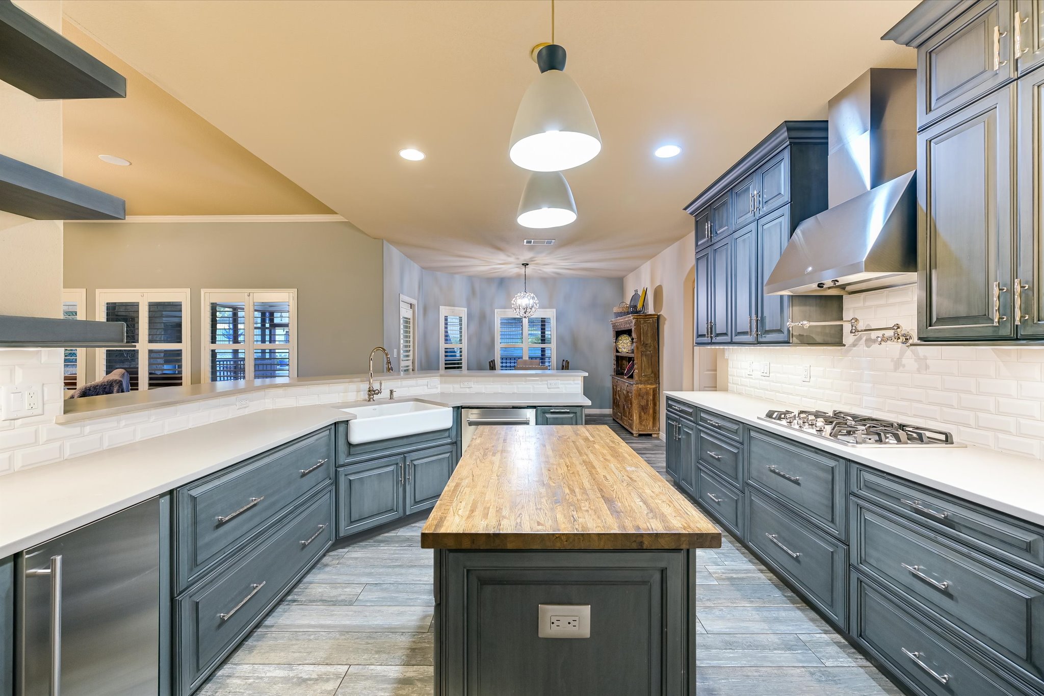 786 Ranchers Club Lane Driftwood, TX 78619 - Photo 5 of 33 Kitchen featuring tasteful backsplash, butcher block counters, decorative light fixtures, a kitchen island, and stainless steel appliances