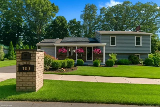a front view of a house with a yard
