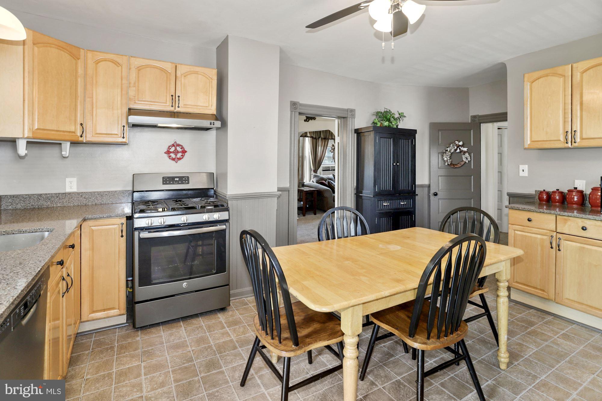 8029 Philadelphia Road Baltimore, MD 21237 - Photo 12 of 29 a kitchen with a table chairs stove and cabinets