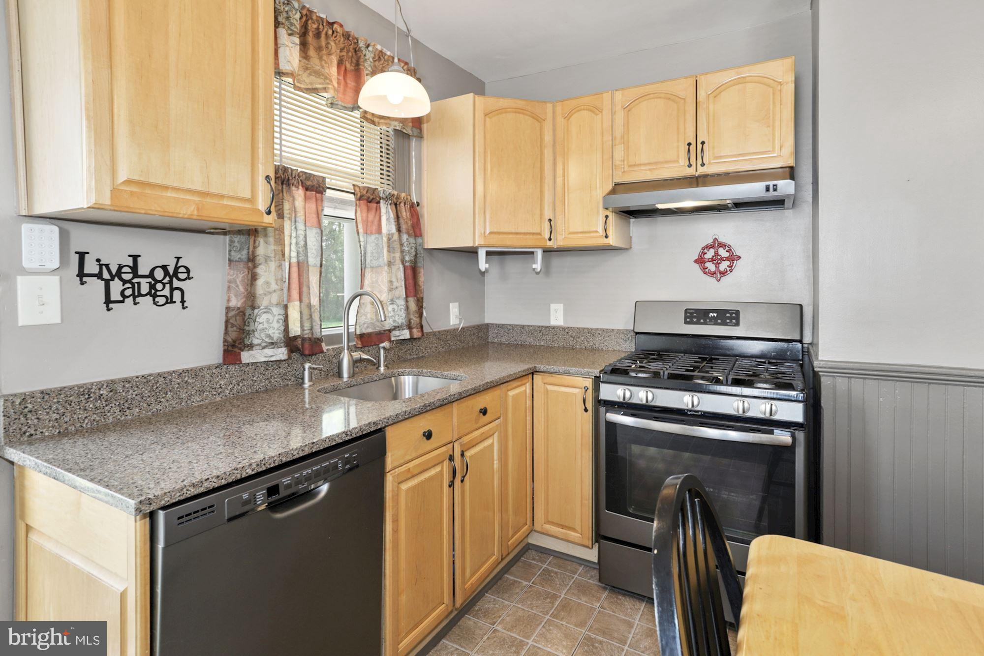 8029 Philadelphia Road Baltimore, MD 21237 - Photo 13 of 29 a kitchen with stainless steel appliances granite countertop a sink stove and cabinets