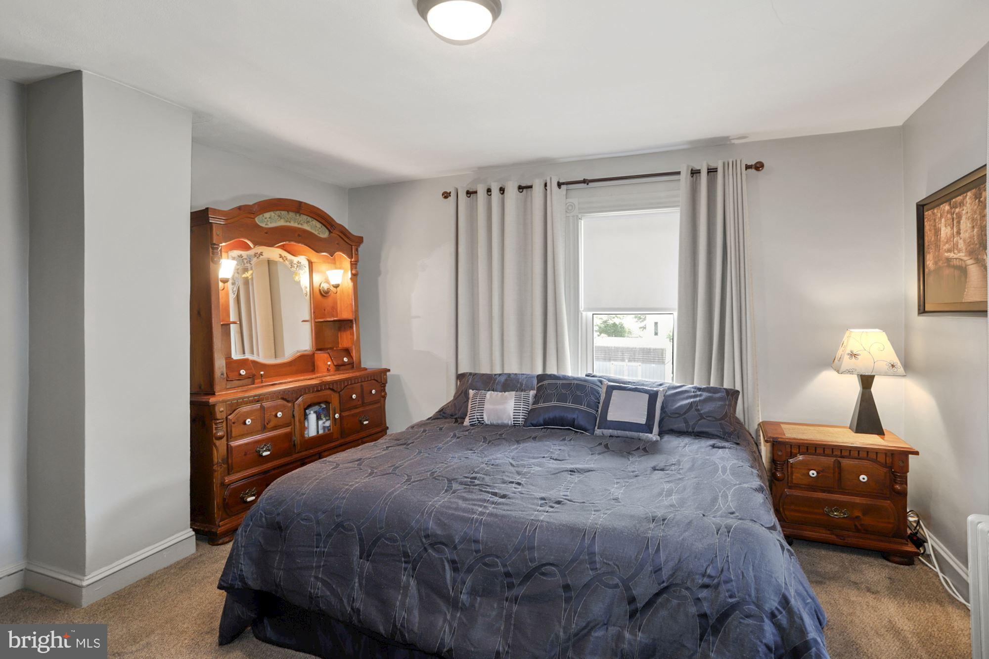 8029 Philadelphia Road Baltimore, MD 21237 - Photo 15 of 29 a bedroom with a bed and wooden floor