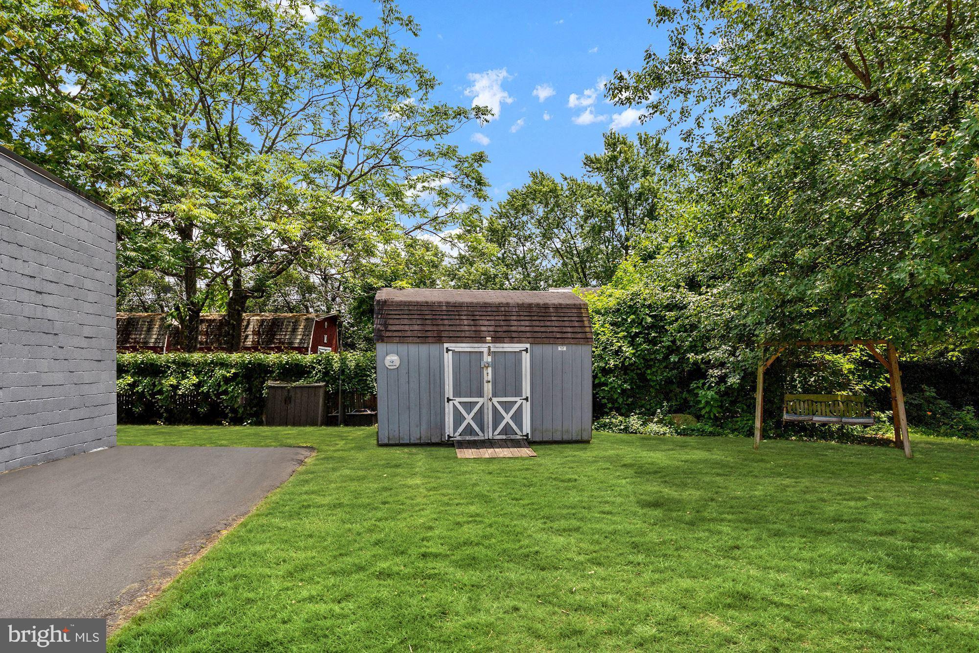 8029 Philadelphia Road Baltimore, MD 21237 - Photo 25 of 29 a view of a tiny house with a big yard and large trees
