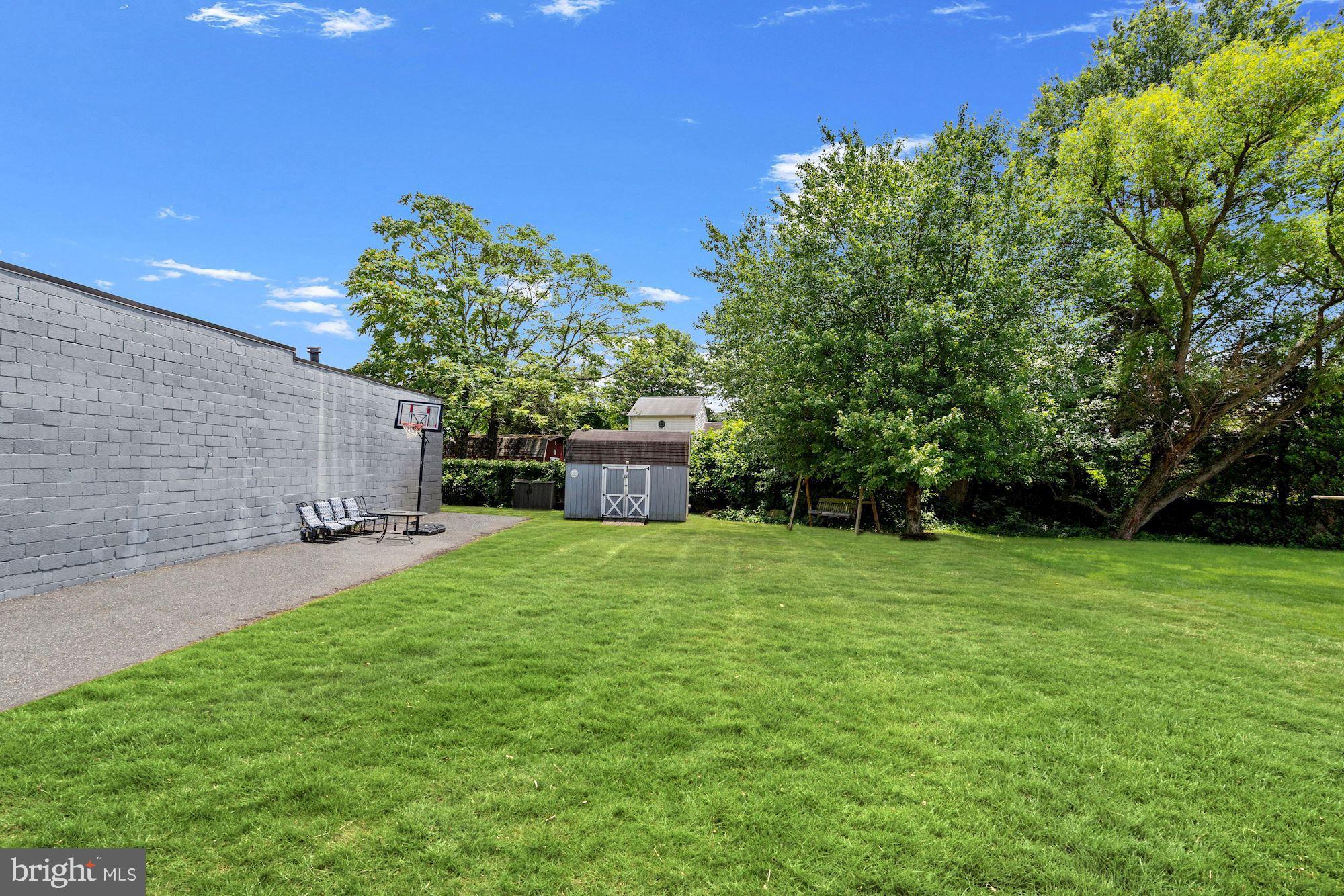 8029 Philadelphia Road Baltimore, MD 21237 - Photo 26 of 29 a backyard of a house with trees and entertaining space