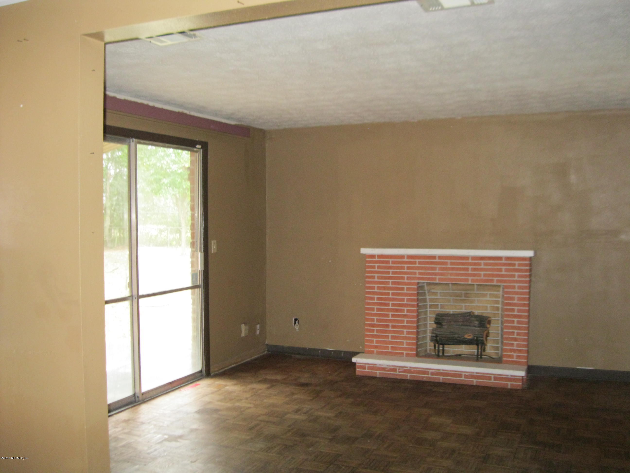 10948 Player Road West Jacksonville, FL 32218 - Photo 6 of 14 a view of empty room with a fireplace