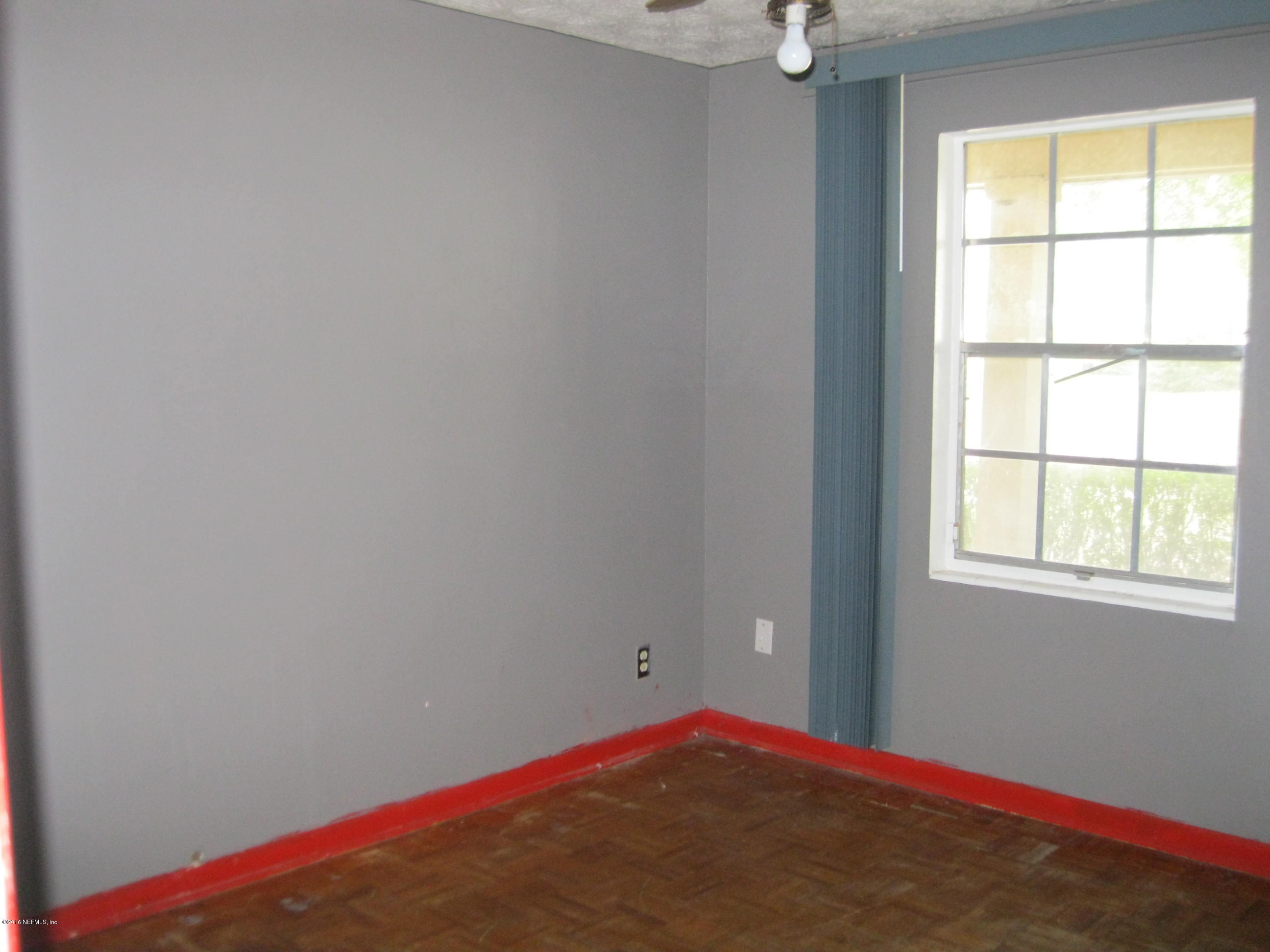 10948 Player Road West Jacksonville, FL 32218 - Photo 8 of 14 a view of empty room with windows