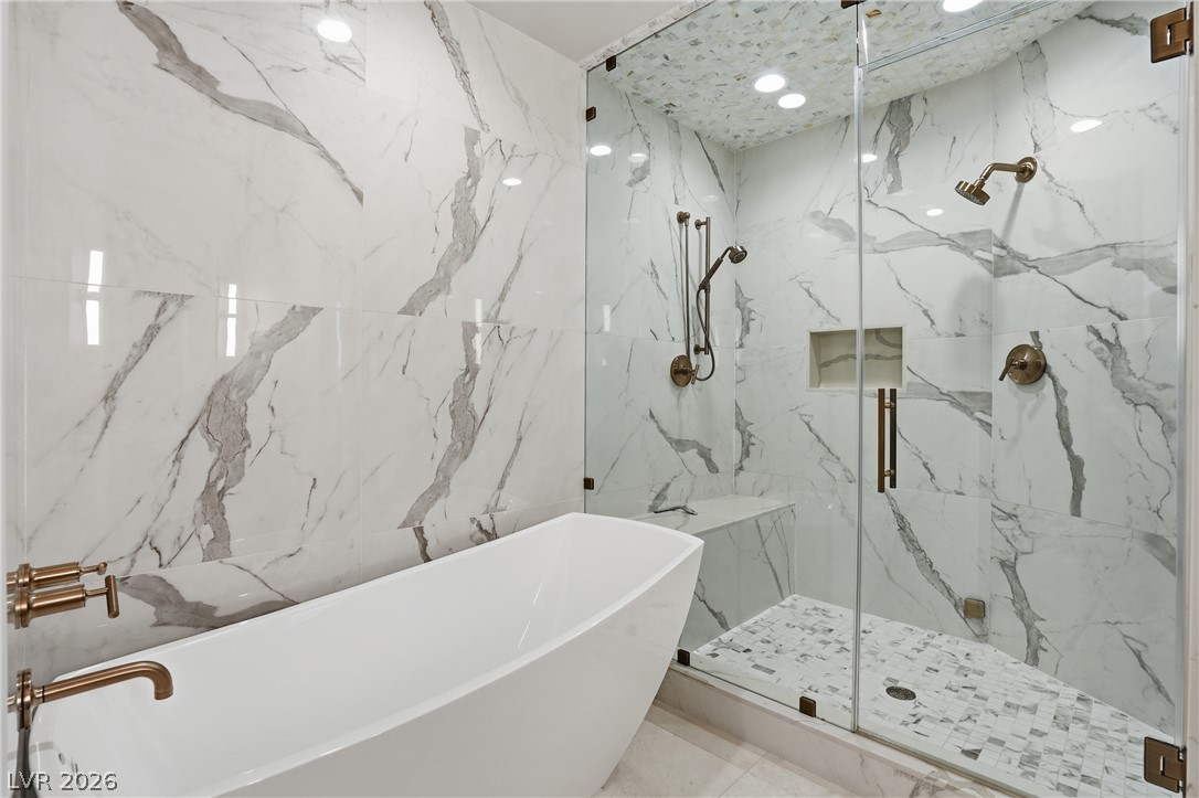 360 East Desert Inn Road, Unit 1701 Las Vegas, NV 89109 - Photo 20 of 33 Indulge in a luxurious primary bathroom, featuring a freestanding tub and a spacious, walk-in shower.
