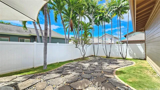 a view of a backyard with a tree