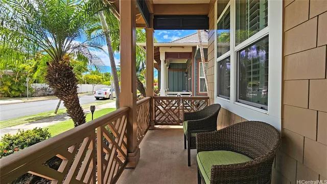 a balcony view with a large window and outdoor seating