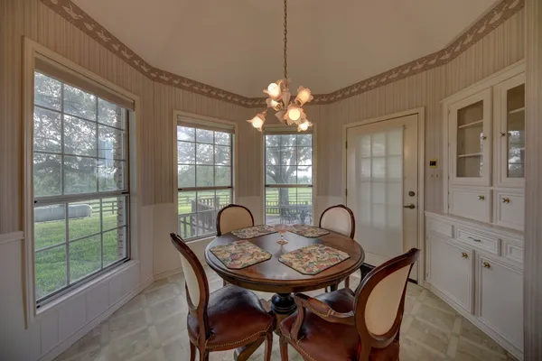 a view of a dining room with furniture wooden floor and chandelier